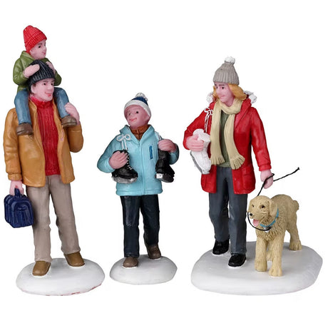 Resin figurines for a Lemax display. One figure is a dad holding a small child on his shoulders. Another figure is a young child holding ice skates. The other figure is of a mom holding ice skates and a dog's leash. The dog is wearing a light blue collar. They're all wearing winter clothes and the ground is snow.