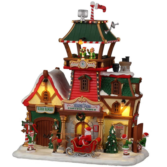 Resin lighted building for a Lemax display. Designed to look like the control tower at the North Pole. There are elves keeping watch in the balcony of the tower. There are elves directing Santa in his sleigh and elves double checking the list.