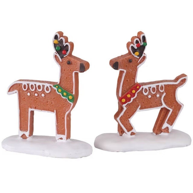 Polyresin figurines for a Lemax display. They're both frosted cookies designed to look like reindeer. Each reindeer features red, green and yellow sprinkles.