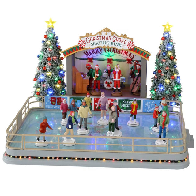 Plastic, animated figure for a Lemax display. Designed to look like an ice skating rink. There are a bunch of people skating around. There's a band on the stage in Christmas outfits and Santa hats. The sign on the stage reads "Christmas Grove Skating Rink. Merry Christmas." There are two tall, decorated Christmas trees on either side of the stage.