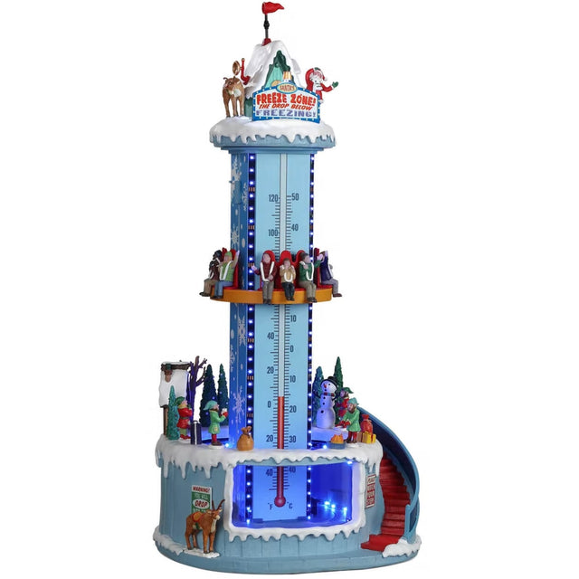Resin village accent for a Lemax display. Designed to look like a winter-themed carnival ride. Santa and a reindeer stand on the top. There are people on the ride and people standing in line. The backdrop of the ride is designed to look like a thermometer.