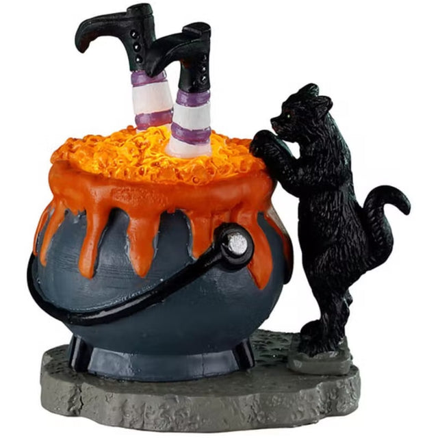Resin figurine for a Lemax display. Designed to look like a boiling cauldron with two witch legs sticking out. There's a black cat standing on it's hind legs to peek inside.
