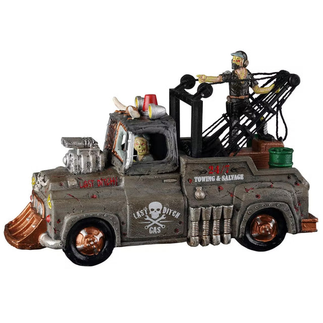 Polyresin accent for a Lemax display. Designed to look like an apocalyptic tow truck. There's a monster driving and a monster hanging out of the bed of the truck.