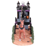 Plastic village accessory for a Lemax Spooky Town display. The grim reaper is driving a stagecoach with a horse leading the way. The stagecoach is pink, orange and gray. There's a black wreath with pink ribbons and a skeleton inside the stagecoach.