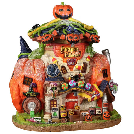 Resin building for a Lemax Spooky Town display. Designed to look like a building made out of a pumpkin. There are jack-o-lanterns everywhere, candy, spiders, candy corn and witch hats. There's a sign on the side that reads "WITCH'S BREW" and underneath is a spout shooting out green and pink liquid. There's a sign next to it that reads "TOXIC."