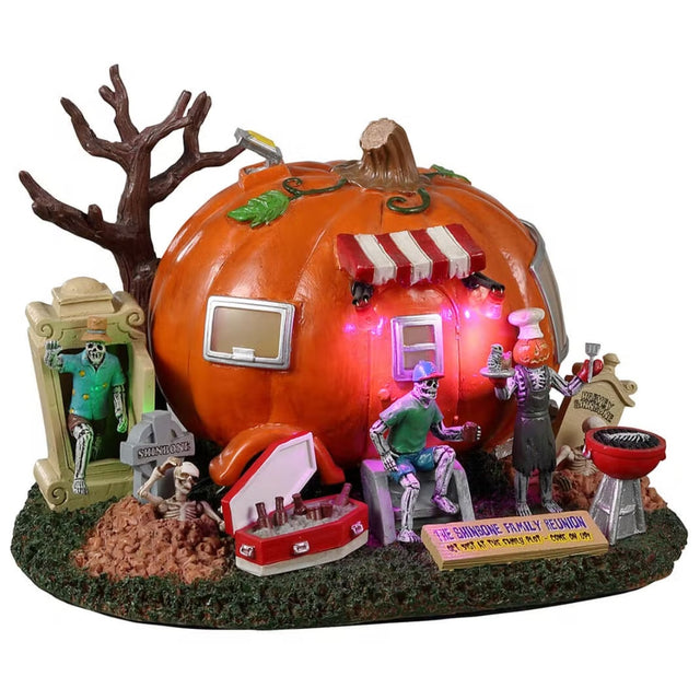 Resin lighted building for a Lemax display. Designed to look like a camper made out of a large pumpkin. There are skeletons enjoying a BBQ.