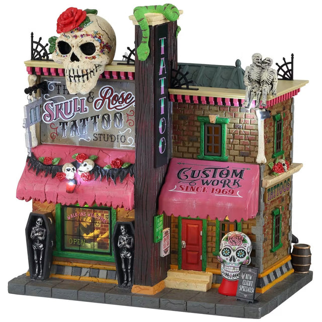 Polyresin lighted building for a Lemax Spooky Town display. Designed to look like a brick tattoo parlor with a giant Día de Muertos skull on the roof. There are skull and skeleton accents throughout.
