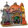 Resin lighted building for a Lemax display. Designed to look like a castle made out of a pumpkin and corn on the cob. There are witches stirring a cauldron and a stack of pumpkins in front.