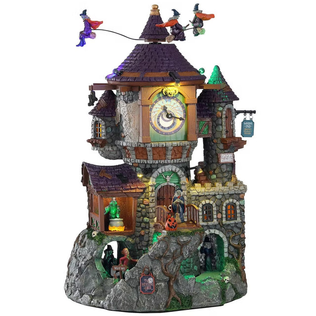 Polyresin building for a Lemax display. Designed to look like a tall, brick castle and clock tower. There are witches flying above. There are monsters and witches around the building.