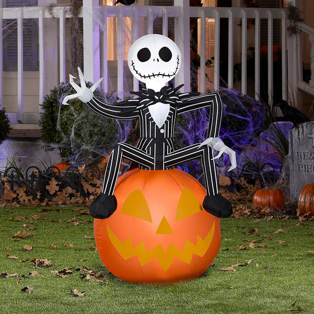 Halloween inflatable shaped like Jack Skellington from the movie The Nightmare Before Christmas. He's sitting on a jack-o-lantern and waving.