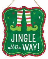 Sign has a red border with green, light green and white polka dots. It features elf legs and it reads "Jingle all the way!"
