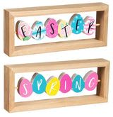 A rectangular wooden tabletop decoration made up of brightly colored eggs. One side reads EASTER and one side reads SPRING