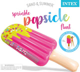 Inflatable pool float shaped like a pink popsicle. The tip of the popsicle looks like it's dipped in yellow frosting with heart shaped sprinkles on it.