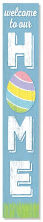 A vertical porch sign reading "Welcome to our Home." The text is white. The background is light blue. The bottom is green and painted to look like grass. The O in the word "home" is a multi-colored egg. Perfect for Easter