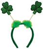 Bopper headband for St. Patrick's Day. Green headband with two green fluffy poofs. Coming out of the fluffy poofs are springs with glitter shamrocks on them.
