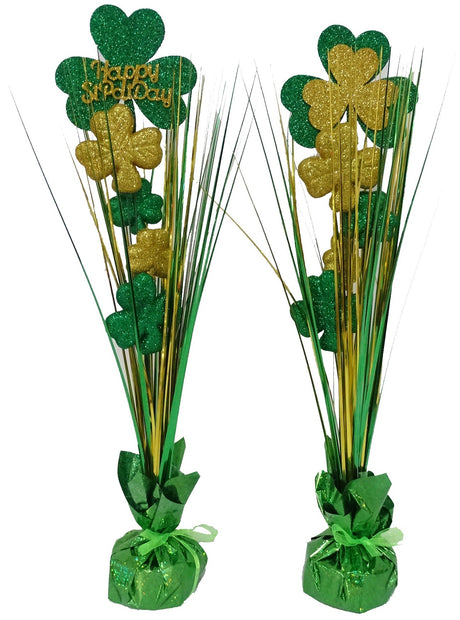 Tabletop party decorations with weight bases. Both decorations feature glittery green and gold shamrocks. One reads "HAPPY ST. PAT'S."