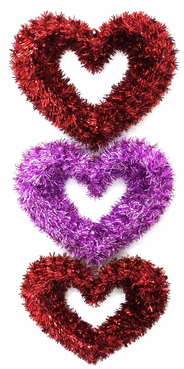 Hanging tinsel decoration for Valentine's Day. Shaped like three tinsel hearts. The top heart is red, the middle heart is pink and the bottom heart is red.