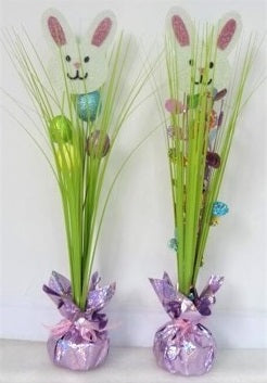 A tabletop decoration for Easter. Designed to look like a bunny hiding in a long, bright green grass with a few glitter eggs