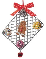 Ornaments designed to look like cookies in silver cut outs or on trays.