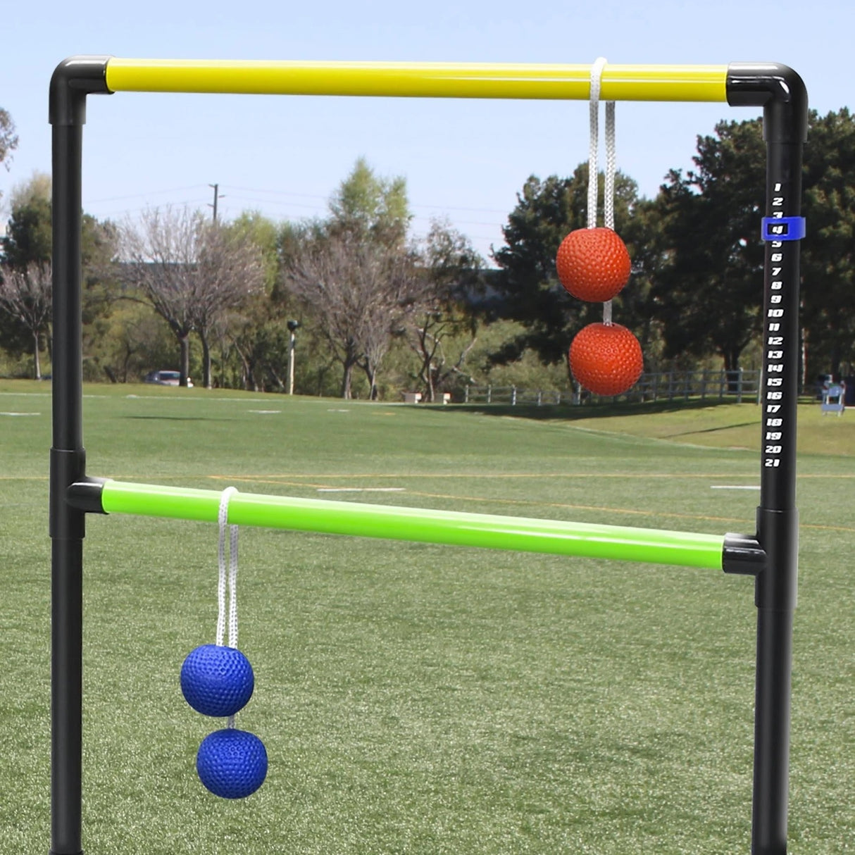 This is a lifestyle image showing two bolos on the ladder toss game.