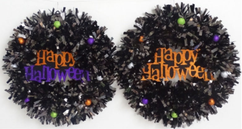 Black tinsel wreath that reads "Happy Halloween."