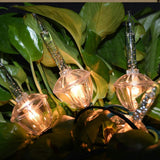 Clear and pure white bubble lights on a green wire.
