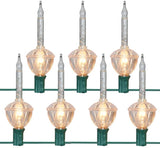 Clear and pure white bubble lights on a green wire.
