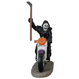 Polyresin figurine for a Lemax display. Designed to look like the Grim Reaper riding a purple motorcycle. There's a pumpkin on the front of the motorcycle. The Grim Reaper is holding a scythe.