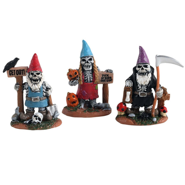 Designed to look like three spooky gnomes. One gnome is wearing light blue overalls and a pointy red hat. He's holding a sign that reads "GET OUT" and there's a crow on the sign and a skull at the gnome's feet. Another gnome is wearing red overalls and a pointy blue hat. He's holding a sign that reads "Pick at your own risk" and is holding a jack-o-lantern. The other gnome is wearing black overalls, a purple pointy hat and is holding a scythe.