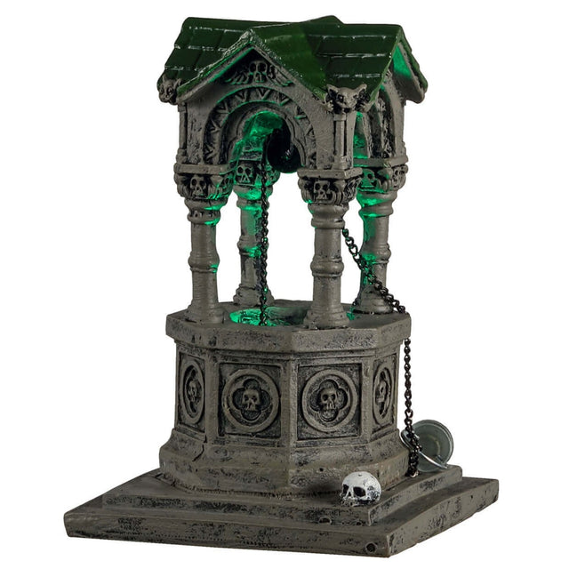 Plastic village accent for a Lemax display. Designed to look like an old, gothic well. The well is decorated with skulls, gargoyle heads and chains. There's a green light coming from inside.