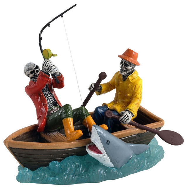 Polyresin figurine for a Lemax Spooky Town display. Designed to look like two skeletons fishing in a row boat. They're both wearing raincoats and rain boots. One of the skeletons have caught a big shark with their fishing rod.
