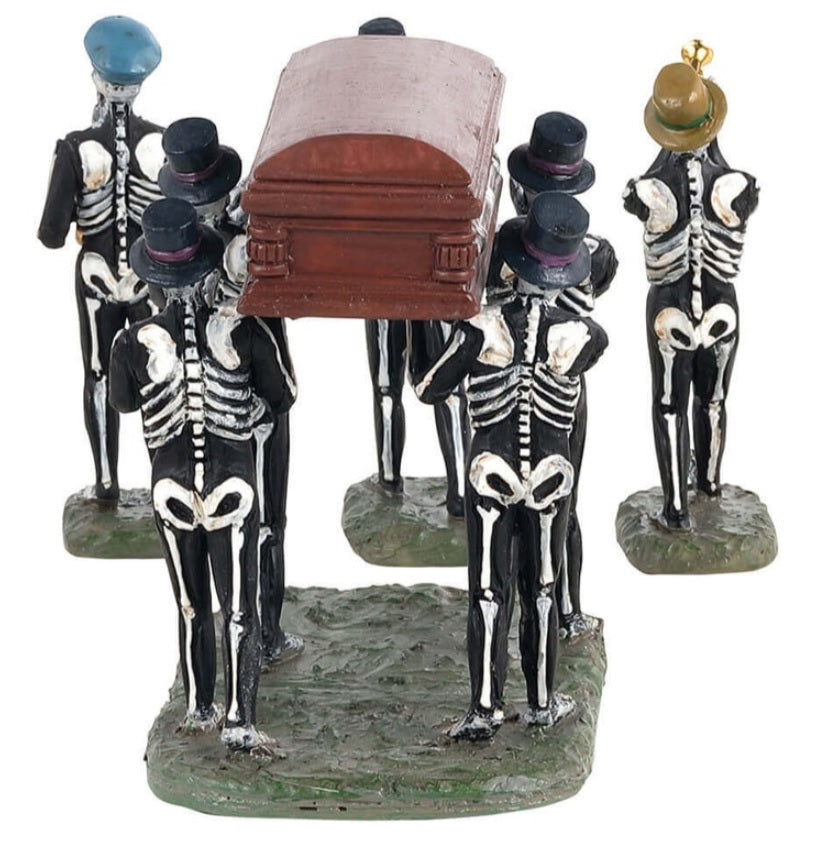 Polyresin figurines for a Lemax Spooky Town display. There are four skeletons holding up a coffin. There are three skeletons playing instruments. Each skeleton is wearing a hat.