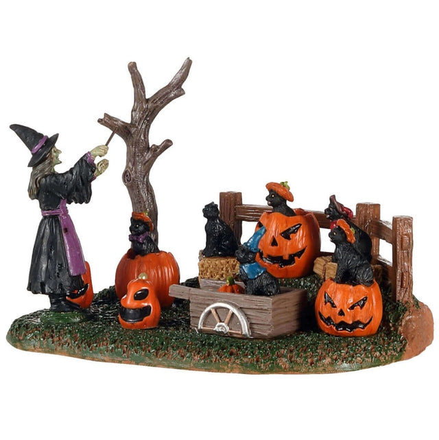 Polyresin village accent for a Lemax display. Designed to look like a witch conducting a chorus of black cats sitting on pumpkins and bales of hay.