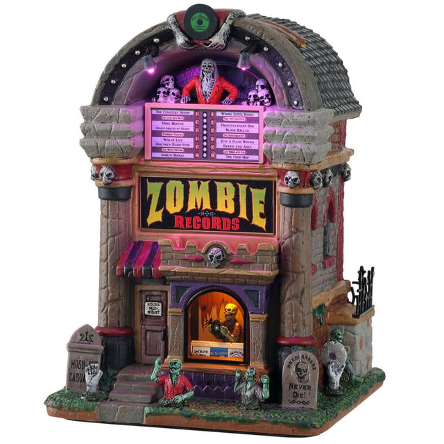 Porcelain lighted building for a Lemax display. Designed to look like a building shaped like a jukebox. There are skeletons and monsters and tombstones. Inside the window you can see a skeleton holding a vinyl record.