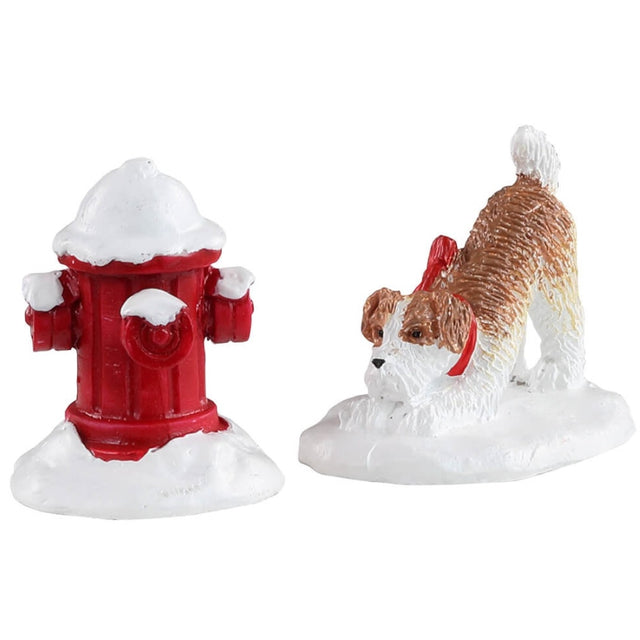 Polyresin figures for a Lemax display. Designed to look like a dog with a red collar standing in snow staring at a red, snow covered fire hydrant.