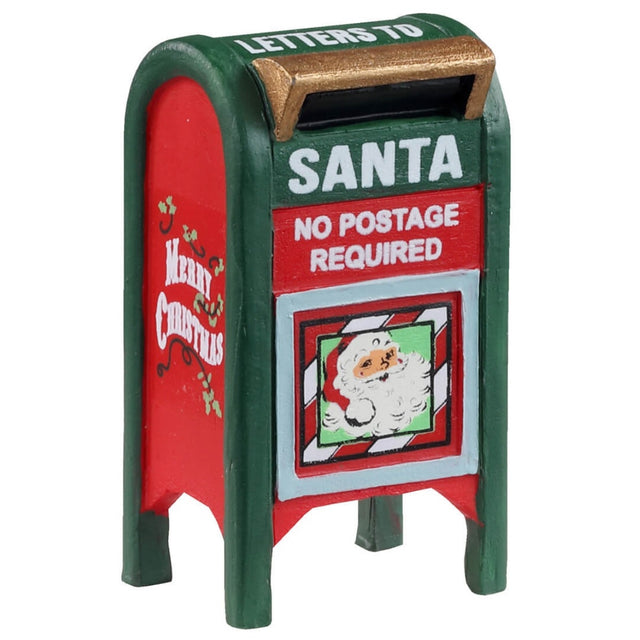 Metal village accessory for a Lemax display. Designed to look like a red and green mailbox. It reads "Letters to Santa. No postage required." It features a cartoon image of Santa's face and it reads "Merry Christmas" on the side.