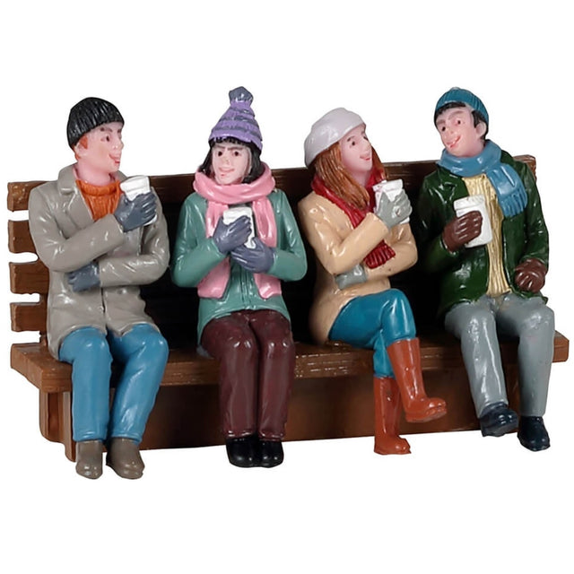 Polyresin figurine for a Lemax Village display. Designed to look like four friends sitting on a wooden bench. They're all smiling, holding cups and dressed in winter clothes.