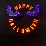 LED Halloween decoration pre-lit with warm white and purple lights. Wire is shaped like a wreath and reads "HAPPY HALLOWEEN" and features two purple bats.