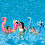 Pool inflatables shaped like seahorses. One is pink and one is blue.