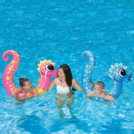 Pool inflatables shaped like seahorses. One is pink and one is blue.