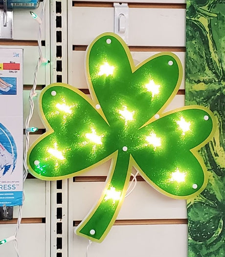 Lighted decoration shaped like a green shamrock.