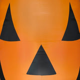 Very large, very bright inflatable shaped like a jack-o-lantern.