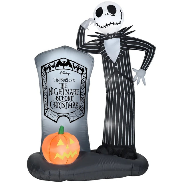 This inflatable depicts Jack Skellington from the movie The Nightmare Before Christmas. He's leaning against a gray tombstone that reads "DISNEY TIM BURTON'S THE NIGHTMARE BEFORE CHRISTMAS." There's an orange jack-o-lantern at the base of the tombstone.