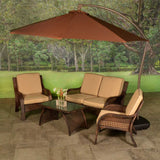 Patio furniture set on a stone patio. The frames are dark brown and the cushions are an orange-ish, tan color.