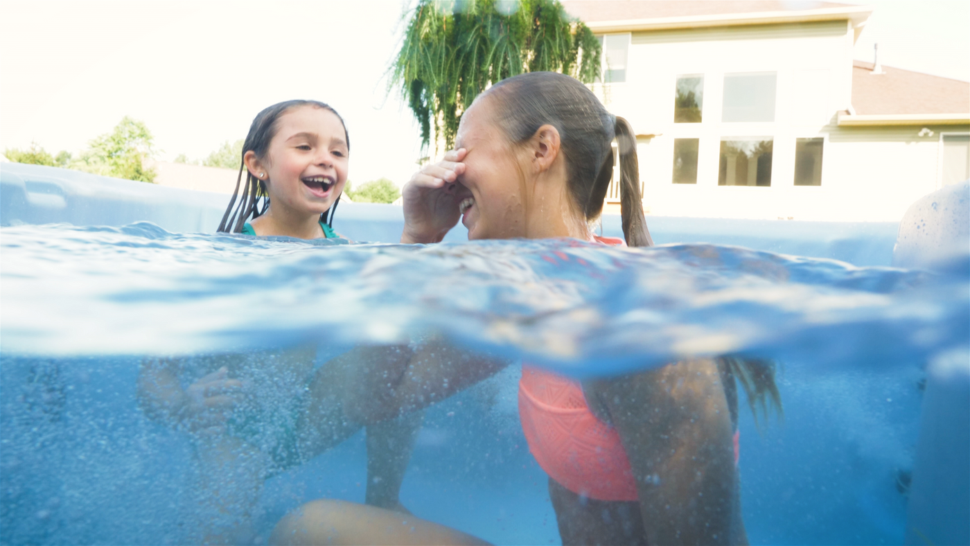 Kids swimming in a hot tub. 