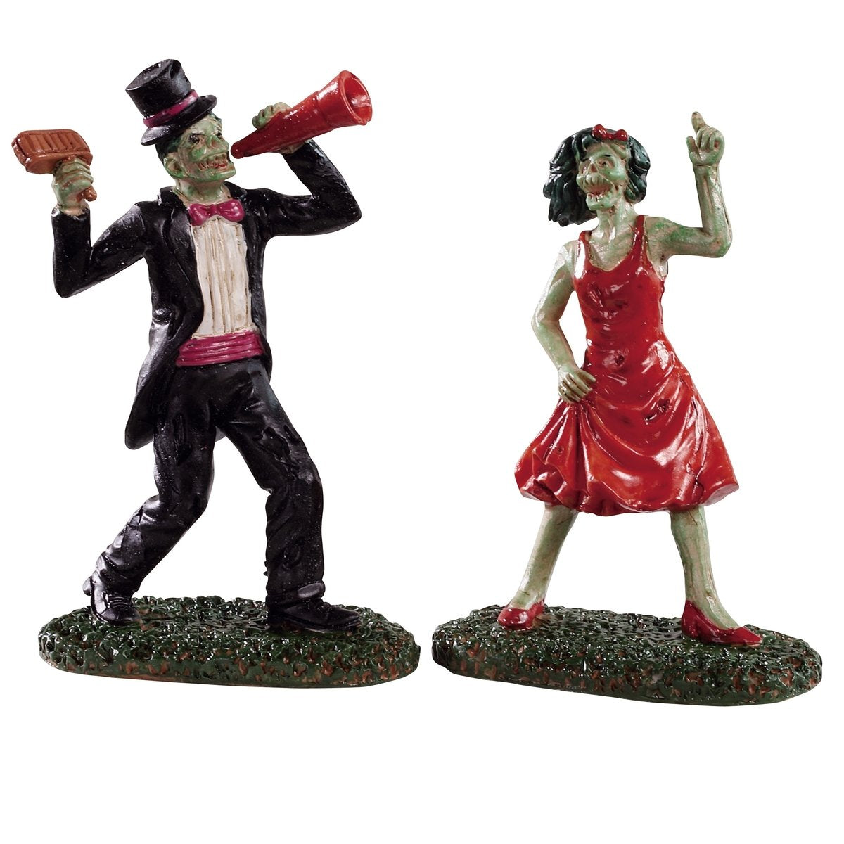 Polyresin figurines for a Lemax display. Designed to look like two zombies dancing. The zombie on the right is wearing a tuxedo with a pink bowtie and pink cummerbund. The zombie on the right is wearing a red dress and red high heels. 