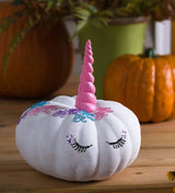 Pumpkin decorating kit comes with self-adhesive jewel designs, paint and a pink unicorn horn.