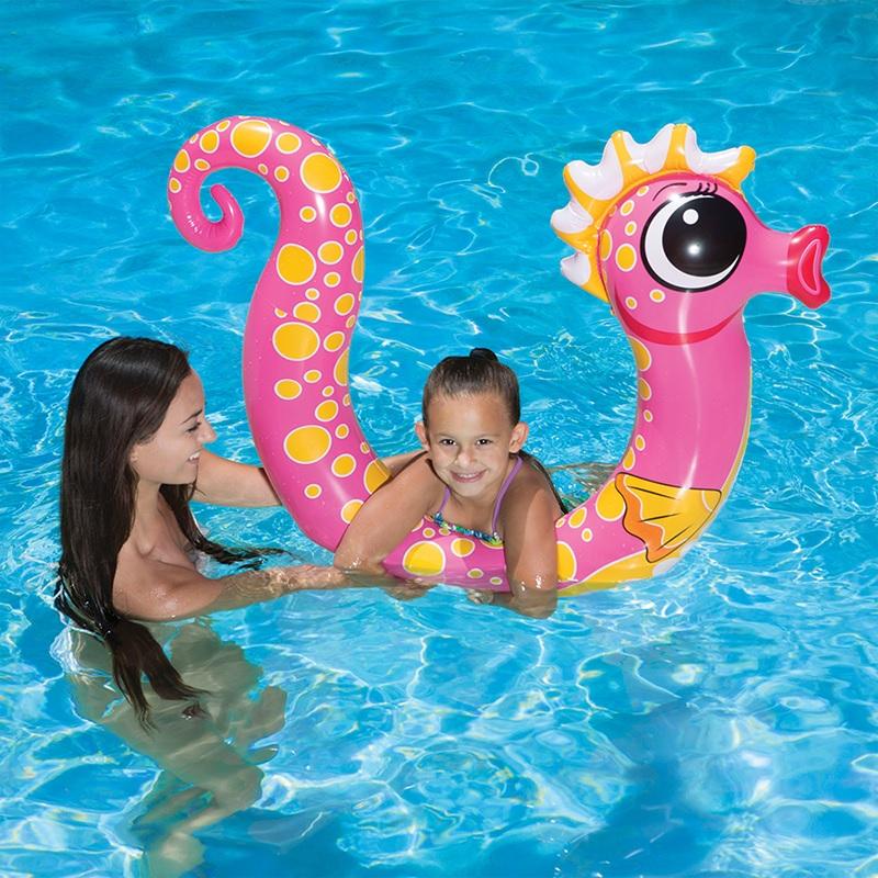 Pool inflatables shaped like seahorses. One is pink and one is blue.