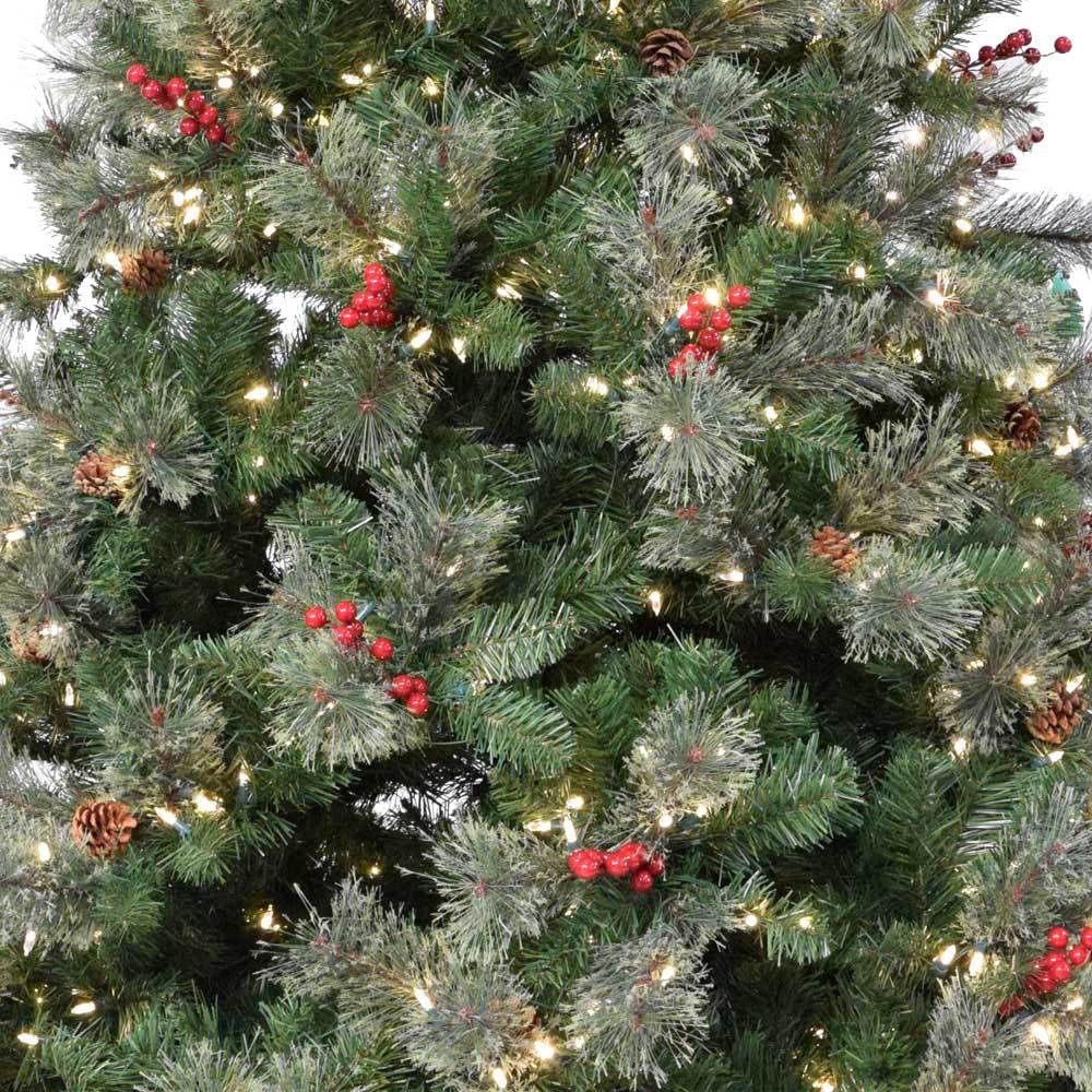 Artificial tree pre-lit with dual lights. Lights change from clear to multi-colored lights. The tree also features red berries and white glitter.