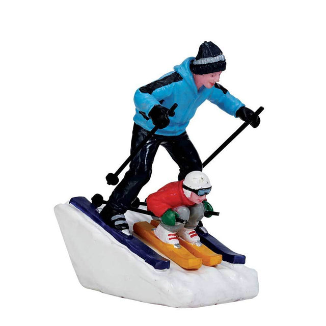 Village figurine for a Lemax display. Designed to look like a dad and son skiing down a hill together.